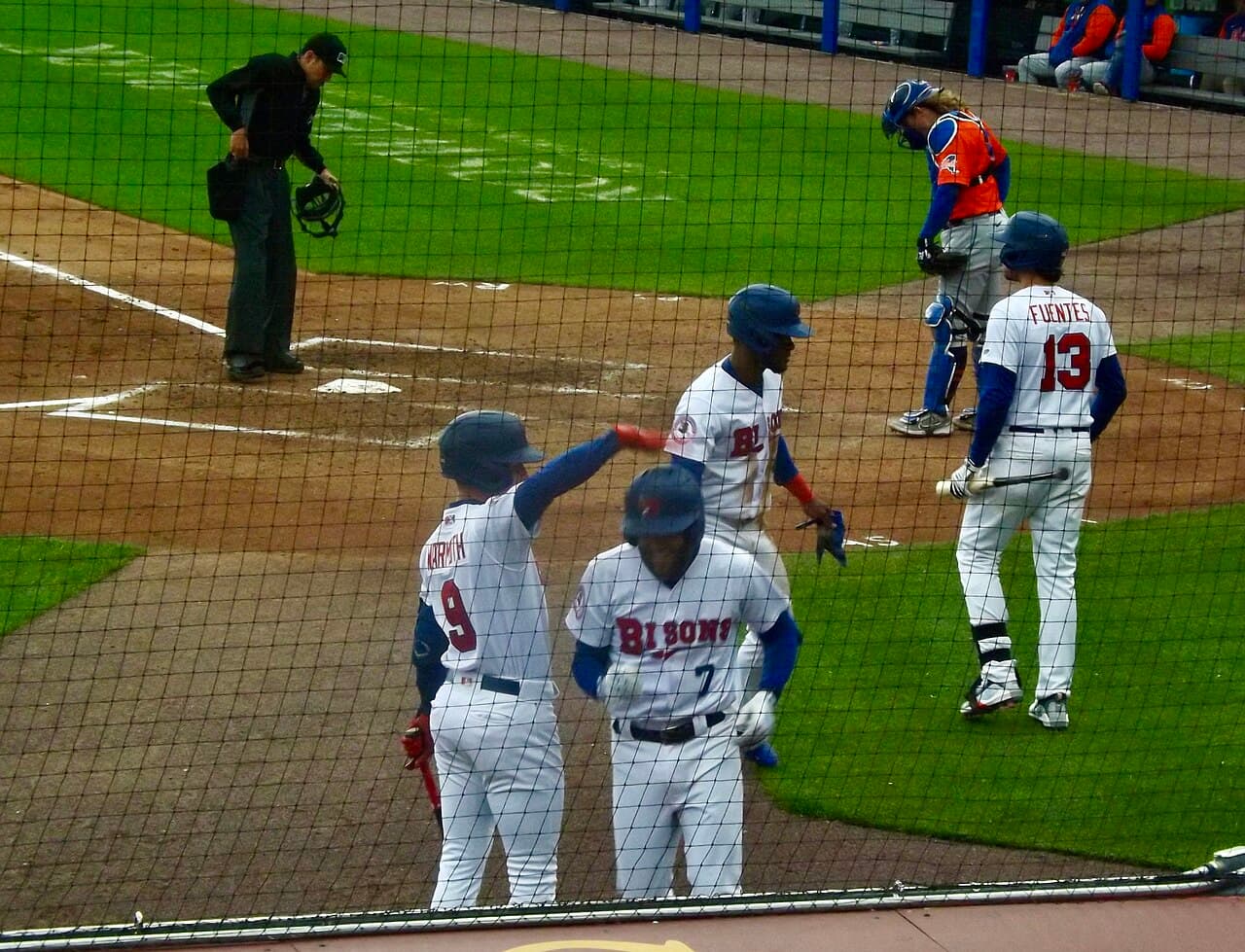 Logan Warmoth, Otto Lopez, and Joshua Fuentes of the Buffalo Bisons fete their teammate, first baseman Cullen Large,…