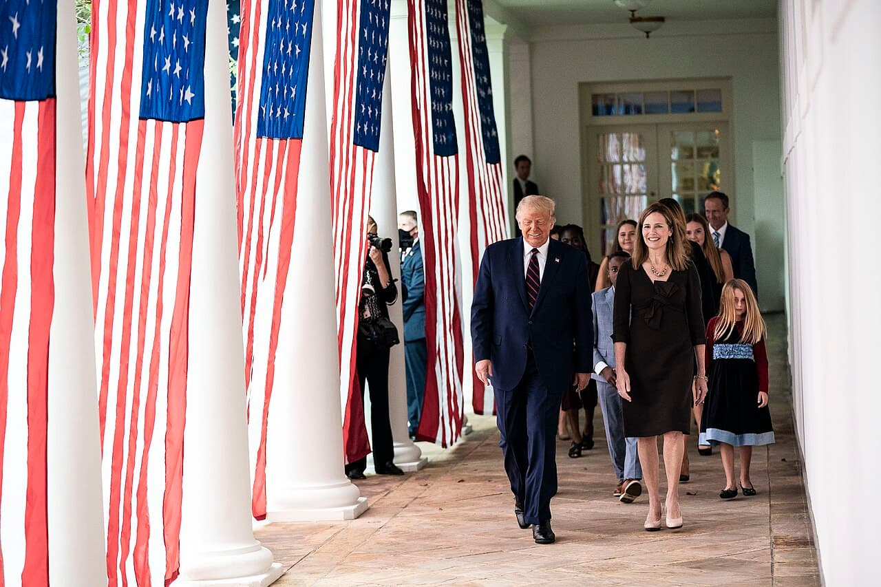 President Donald J. Trump walks with Judge Amy Coney Barrett, his nominee for Associate Justice of the Supreme Court…
