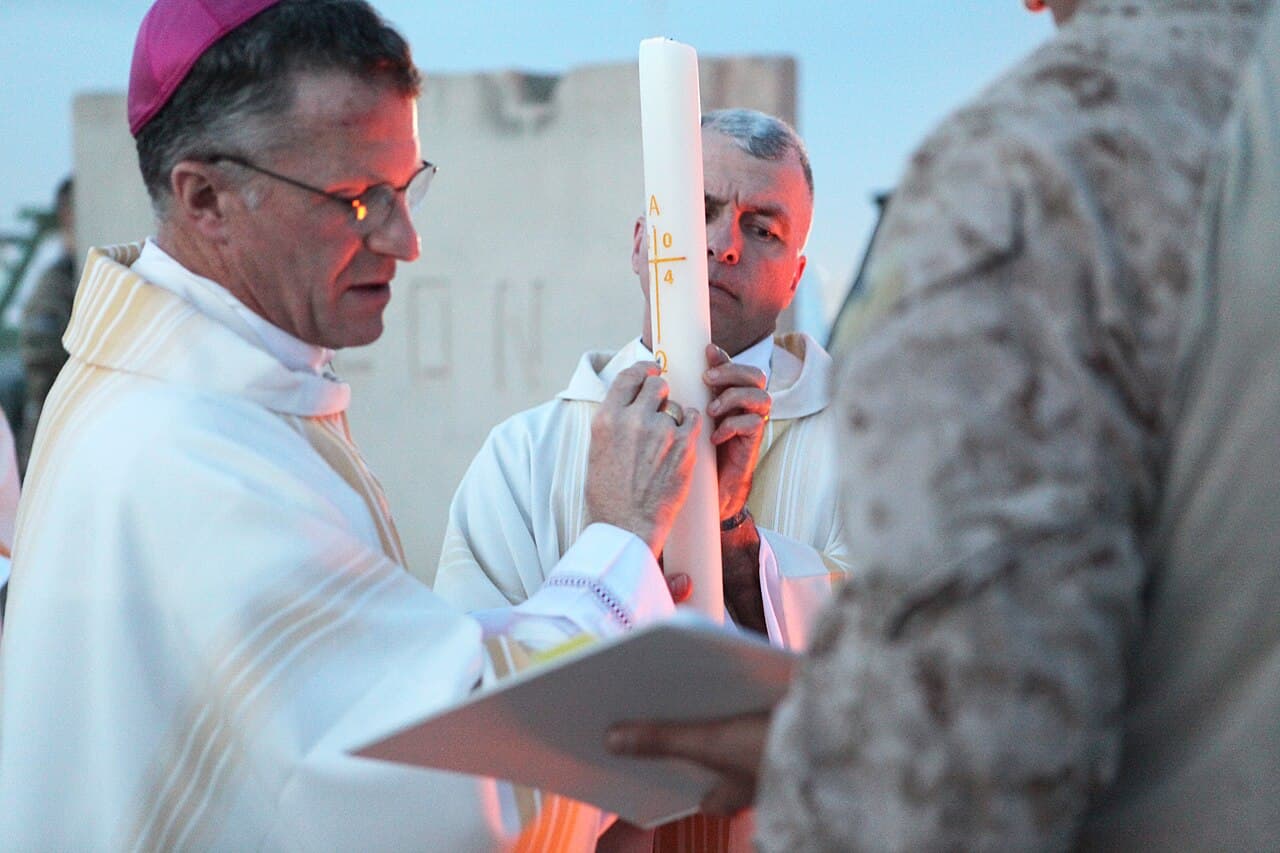Archbishop Timothy P. Broglio, left, who leads the Roman Catholic Archdiocese for the military services, conducts…