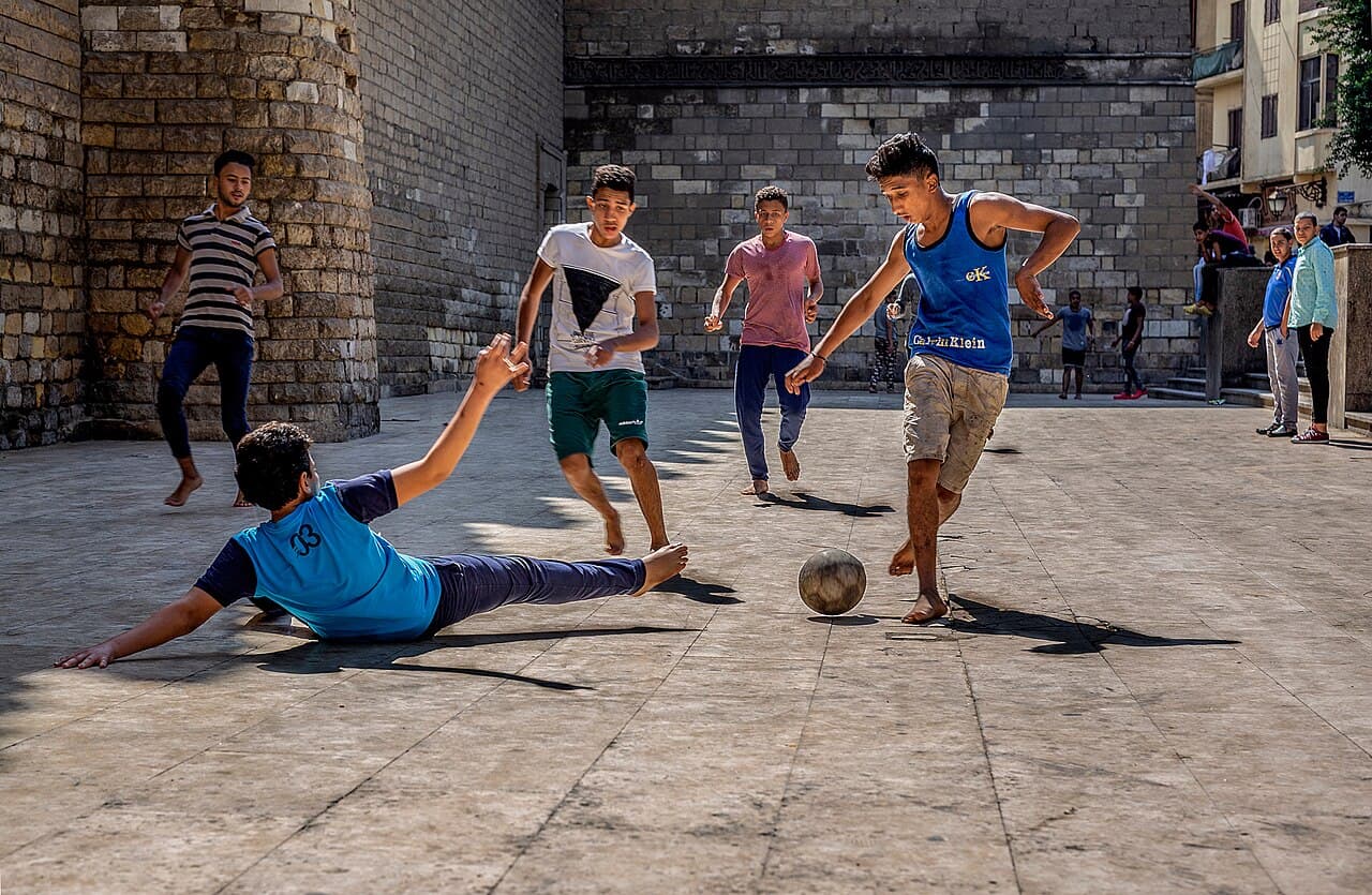 Children playing street football in Egypt, one of the most famous games in Africa. Location: Al-Mu'izz Street, at the…