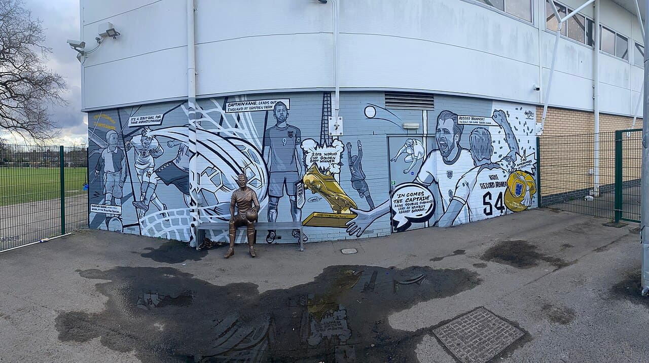 Panoramic photo of the Harry Kane statue and mural at the Peter May Sports Centre, Walthamstow, London