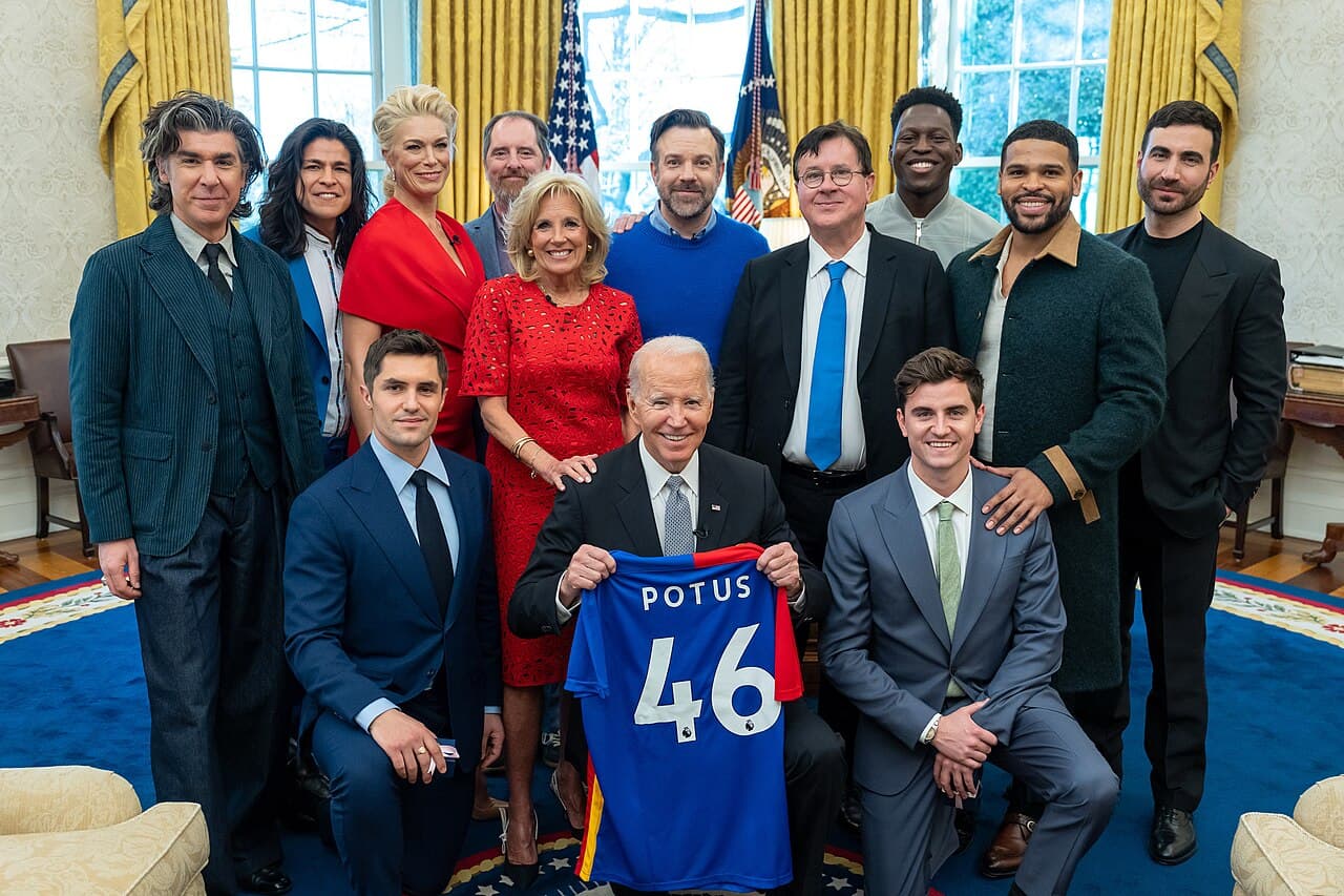 President Joe Biden, holding an AFC Richmond jersey, and First Lady Jill Biden greet the cast of “ Ted Lasso ” on…