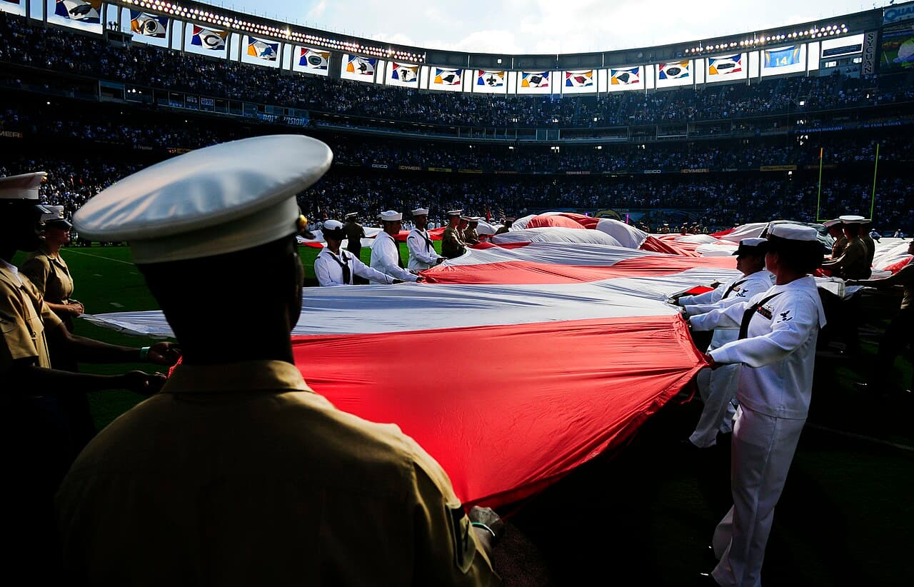 SAN DIEGO (Aug. 11, 2011) Sailors and Marines prepare to spread the American flag across the field at Qualcomm Stadium…