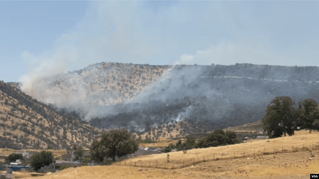 Burning forest and smoke following Iranian drone and missile strikes on the Komala of the Toilers of Kurdistan's…