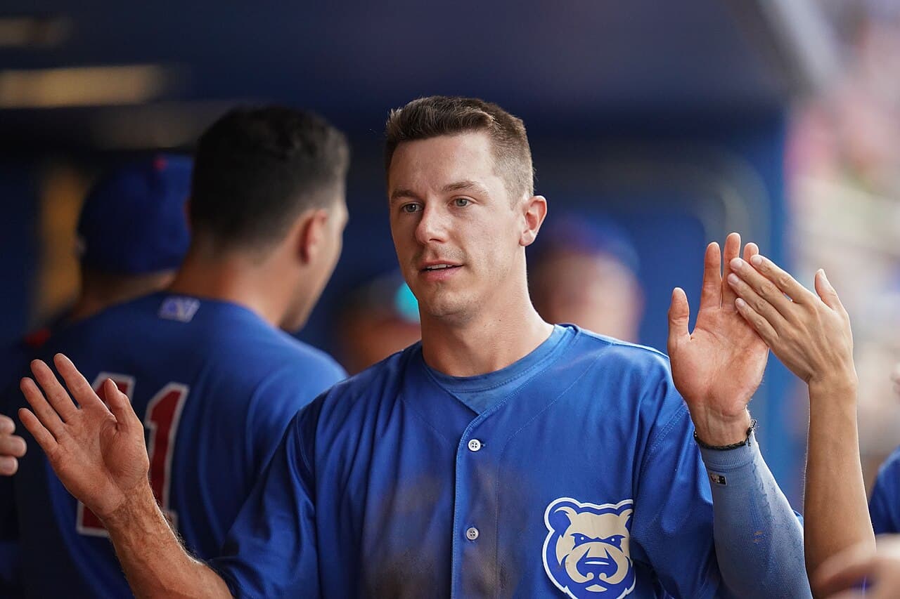 Jared Young high fives teammates in the dugout with the Iowa Cubs during a game at Werner Park in Nebraska in 2022