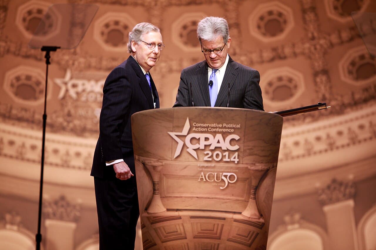 Senators Mitch McConnell of Kentucky presenting Tom Coburn of Oklahoma a gun at the 2014 Conservative Political Action…