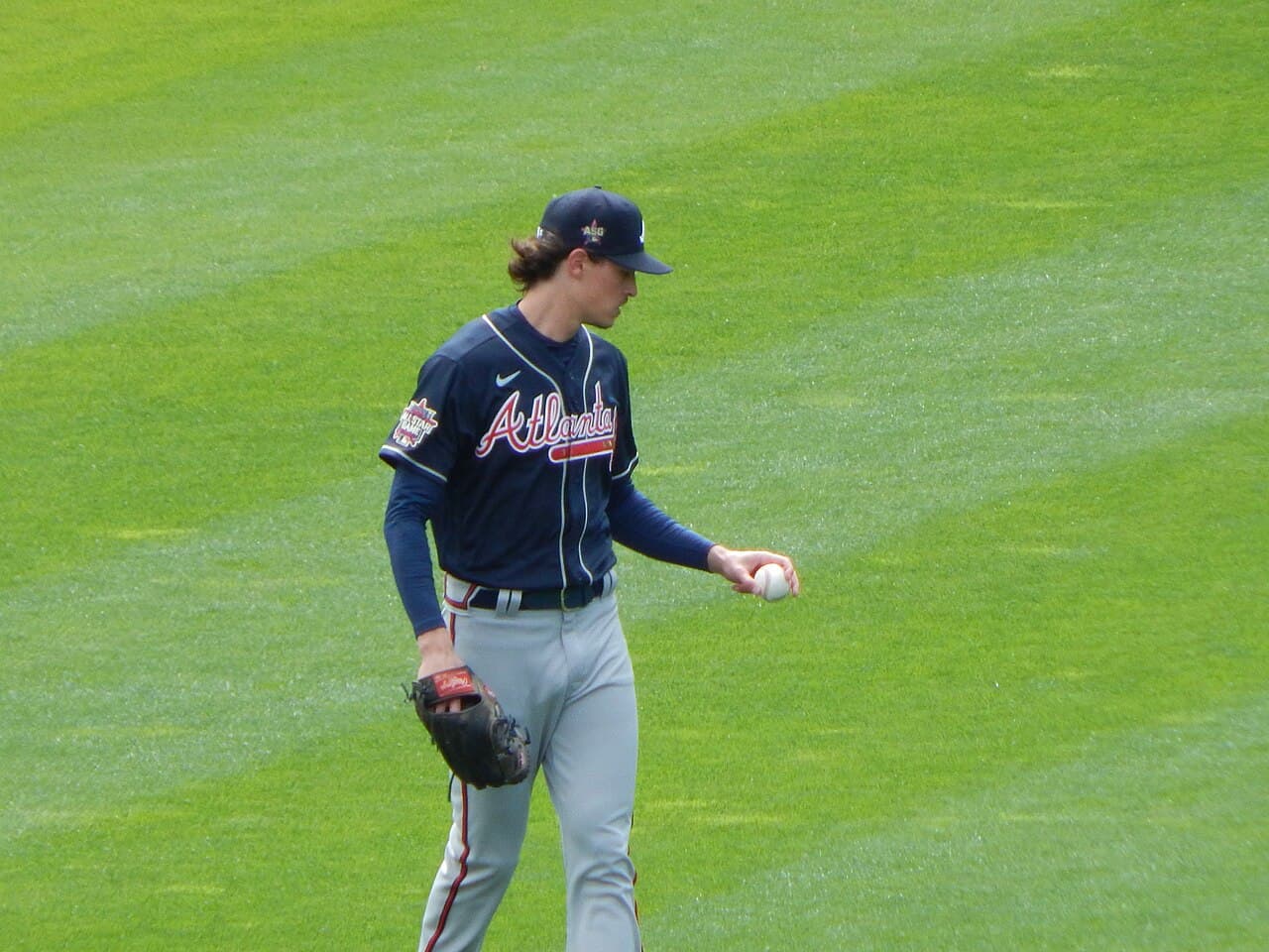 Max Fried holding a ball while warming up before the first game of the 2021 season.