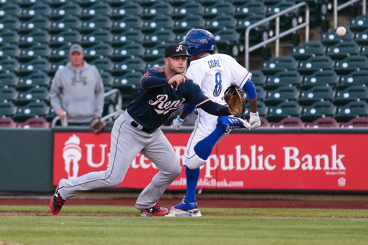 Christian Walker of the Reno Aces (left) lunges to catch a ball as Terrance Gore of the Omaha Storm Chasers reaches…