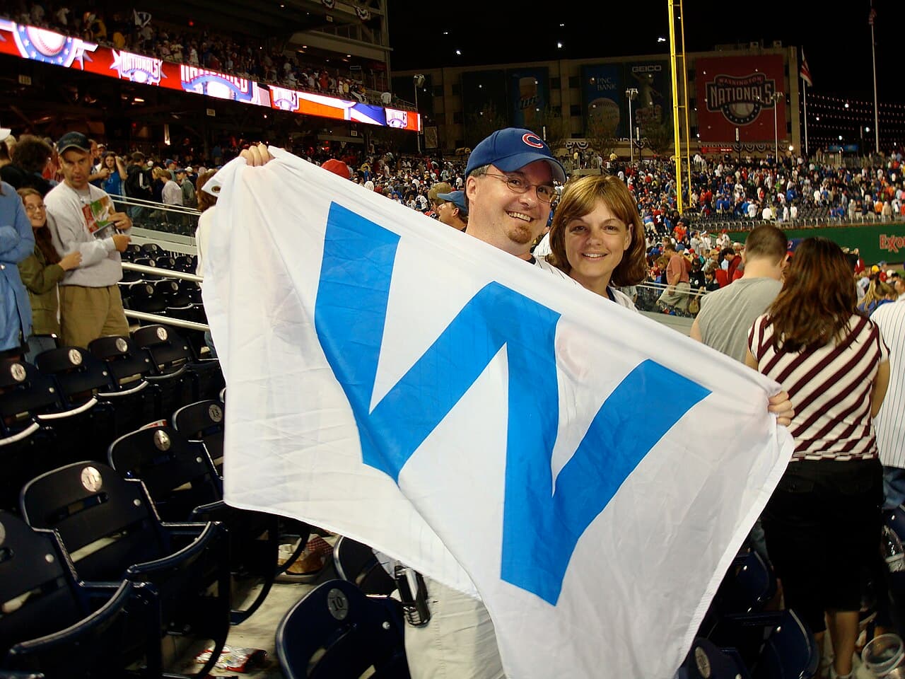 Chicago Cubs fans show their Cubs Win Flag at the Cubs' first win at Nationals Park